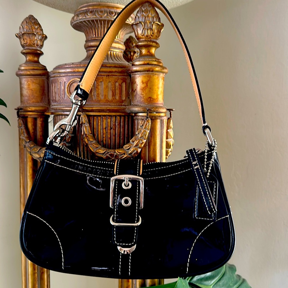 Coach mini patent leather purse with silver hardware and tan trim.